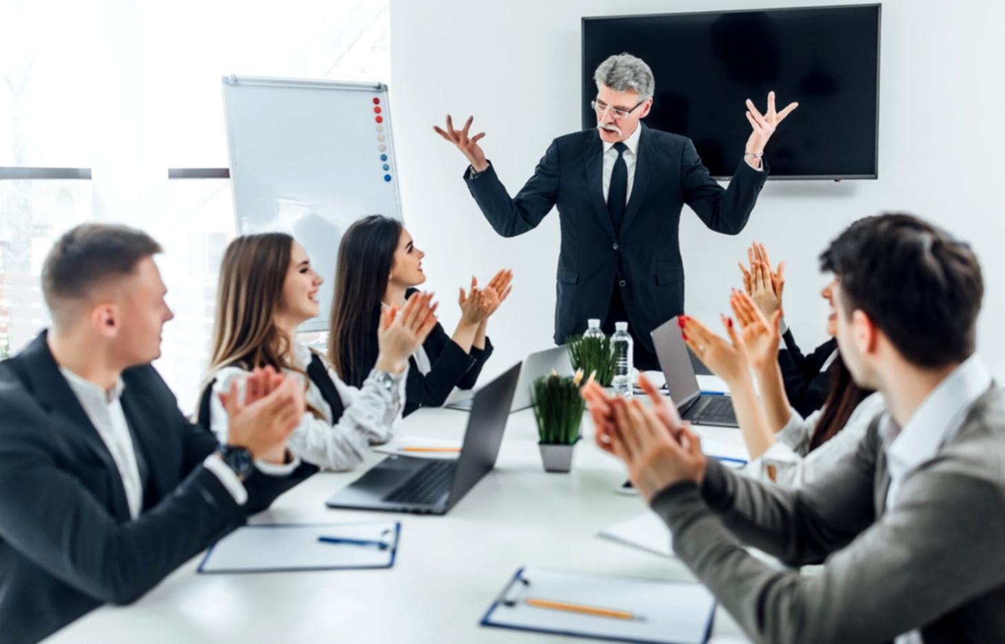 Professional presenting financial charts to engaged business audience